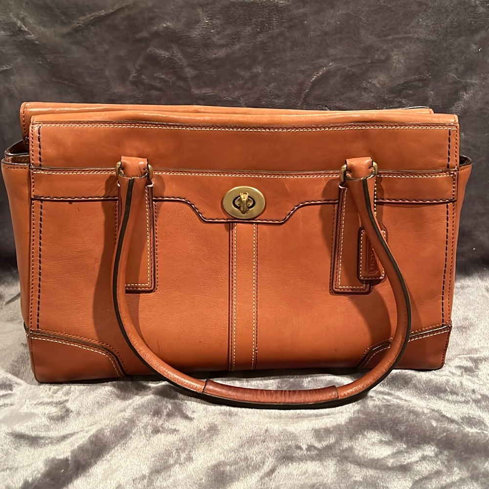 Coach brown leather purse, 9.5” x 13”. Inner and outer pockets.